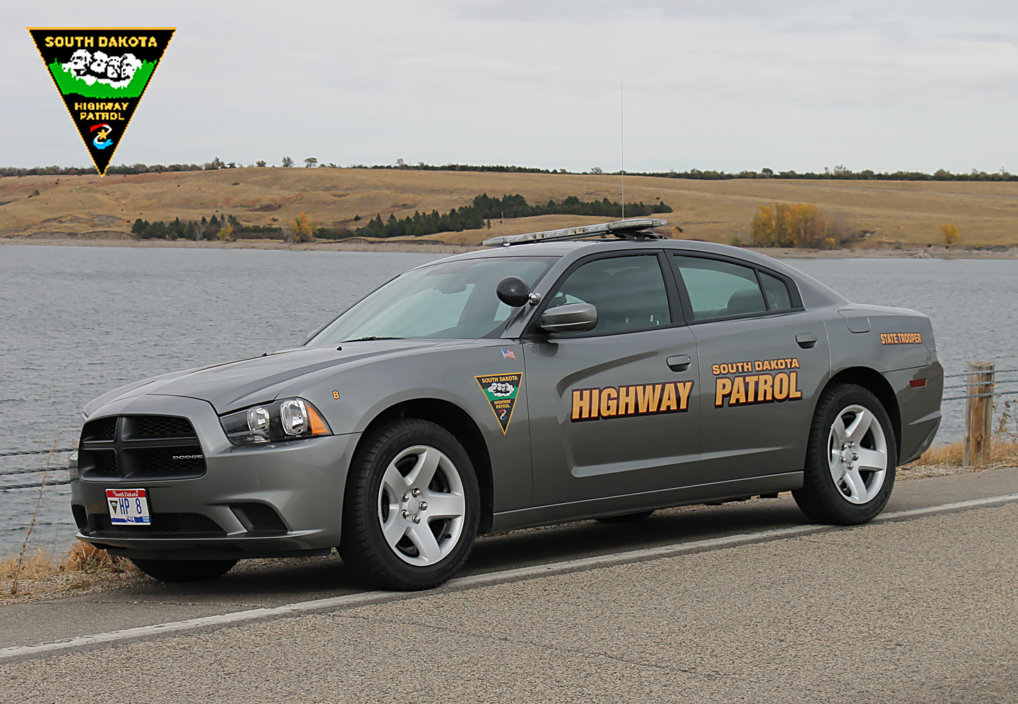 A silver police car that says "South Dakota Highway Patrol" on the side of it.