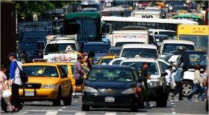 Crowded street full of cars; traffic jam and pedestrians.