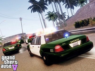 Video game rendered image of four police cars in hot pursuit; screenshot from the video game Grand Theft Auto V.