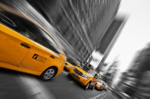 Yellow taxi's speeding by in a blur.