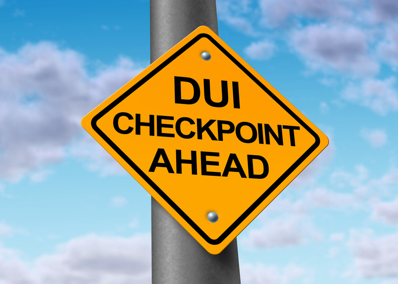 Yellow sign that says "DUI Checkpoint Ahead."