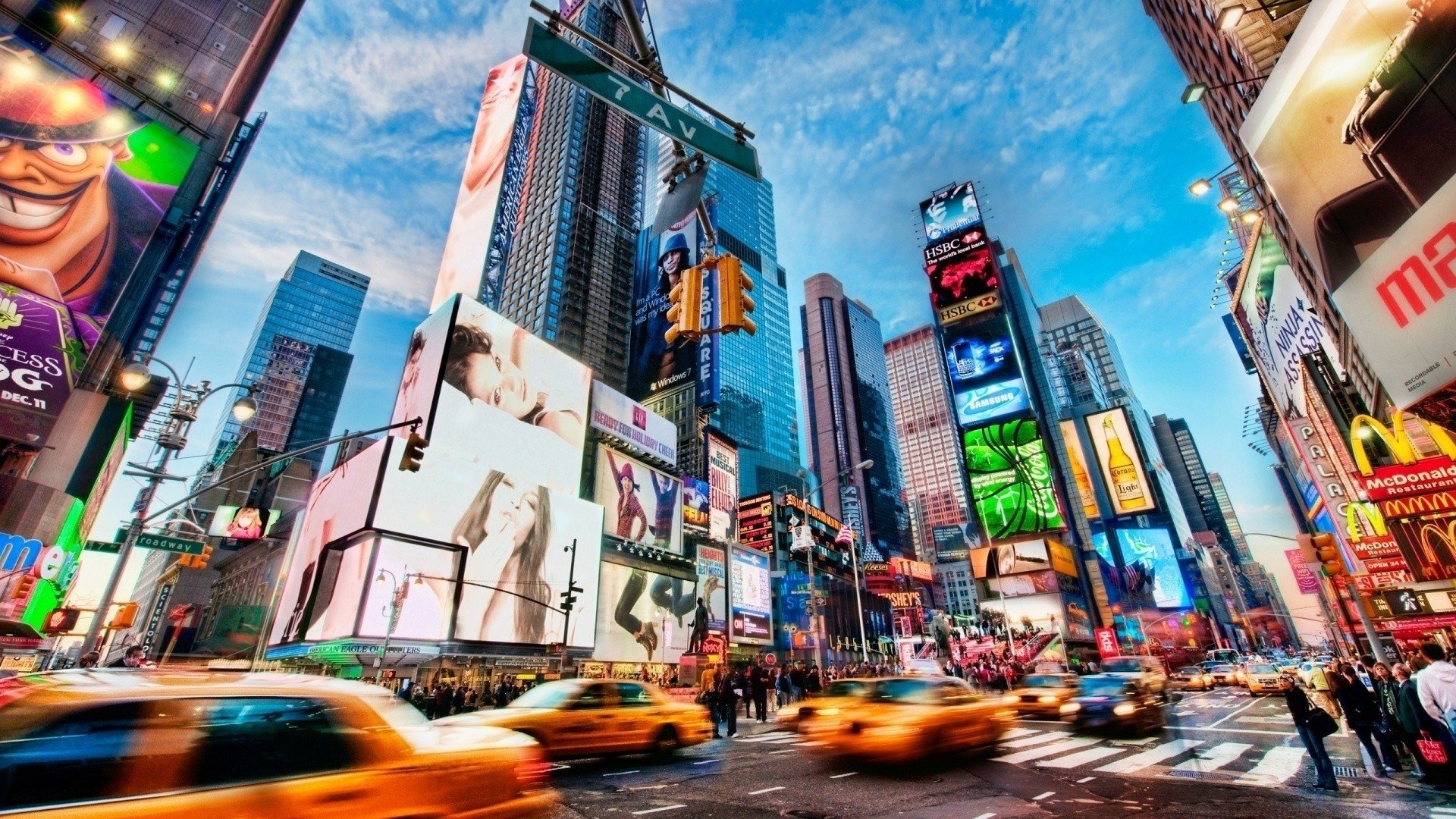 Futuristic looking image of New York City with a bunch of yellow taxi's blurred as they speed by.